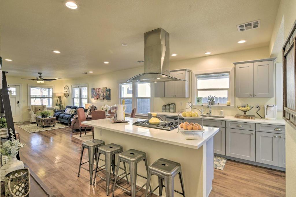 a kitchen with a island with bar stools at Ideally Located Chico Home - Fire Pit and Grill in Chico