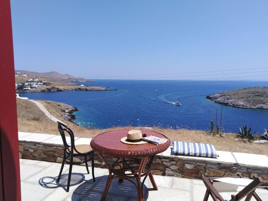 a table with a hat sitting on top of a patio at Kythnos - Loutra- House in Loutrá