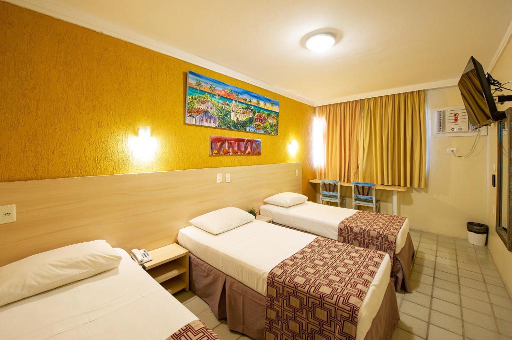 Cama ou camas em um quarto em Hotel Costeiro