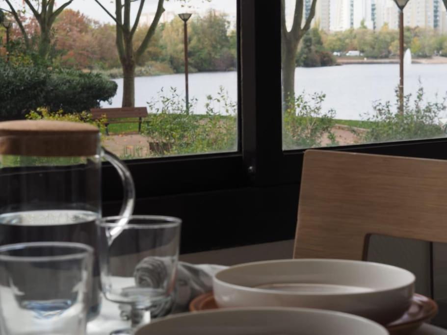 a table with a glass of water and a plate of food at La Charmille du Lac in Créteil