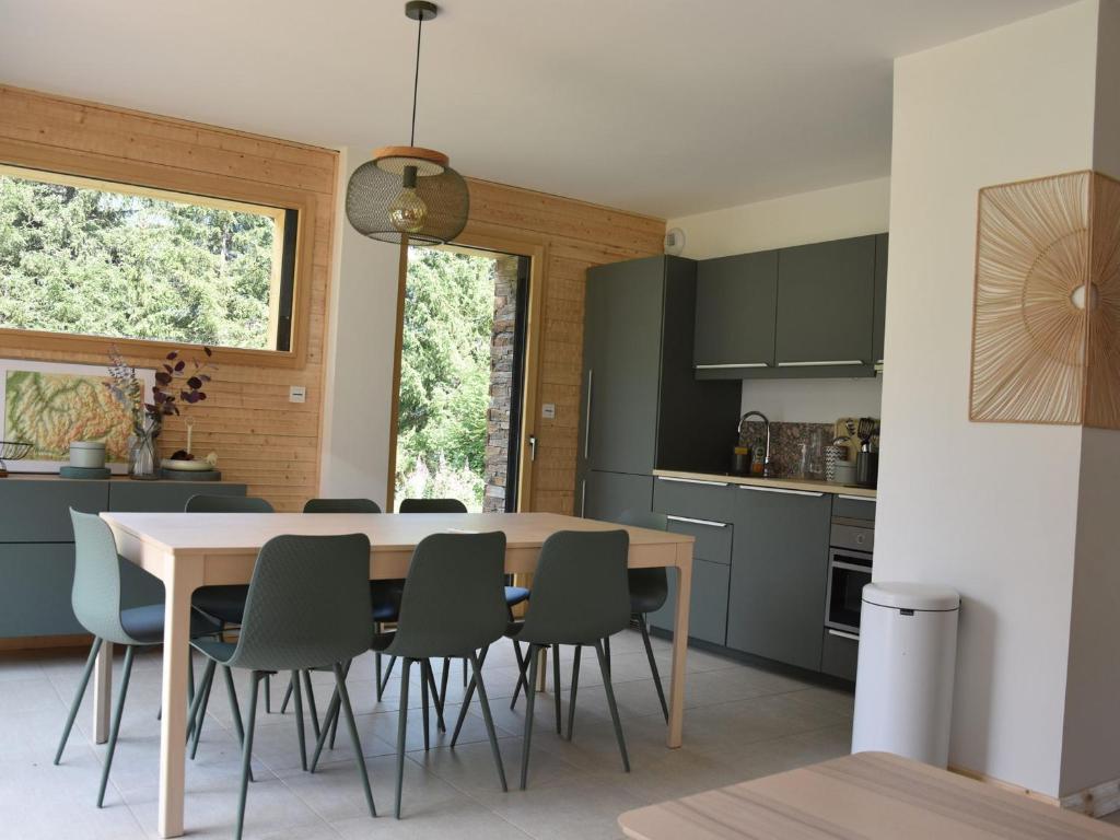 a kitchen and dining room with a table and chairs at Chalet récent proche centre, piscine et patinoire, avec terrasse et parking couvert - FR-1-464-189 in Pralognan-la-Vanoise
