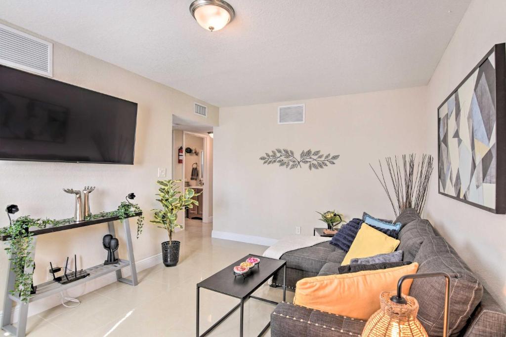 a living room with a couch and a flat screen tv at Fort Lauderdale Apt Near Beaches and Shopping! in Fort Lauderdale