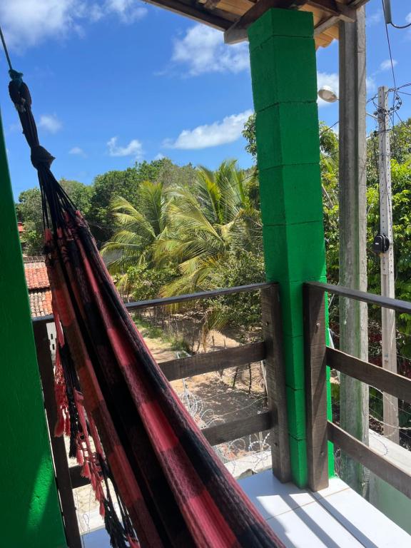 a hammock in a resort with a view of the beach at Apartamento em Pipa in Pipa