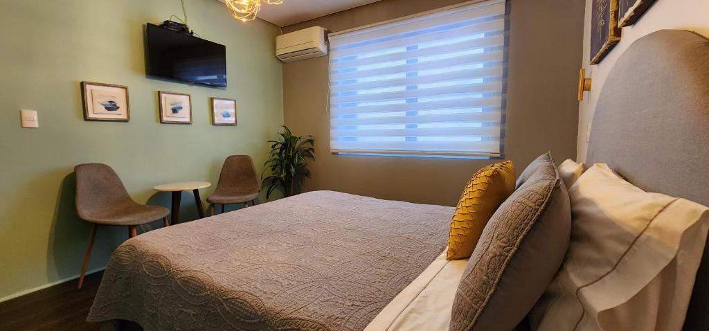 Postel nebo postele na pokoji v ubytování Hotel Voila la Moneda
