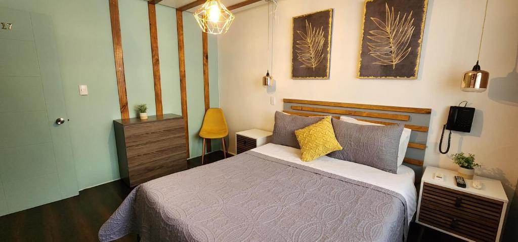Postel nebo postele na pokoji v ubytování Hotel Voila la Moneda