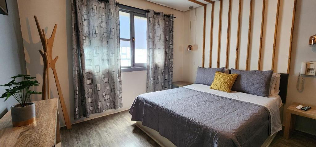 Postel nebo postele na pokoji v ubytování Hotel Voila la Moneda