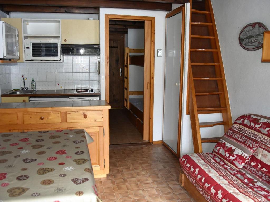 une petite cuisine avec un escalier menant à une chambre dans l'établissement Studio en mezzanine, près des pistes, balcon sud/est, garage privé - FR-1-464-35, à Pralognan-la-Vanoise