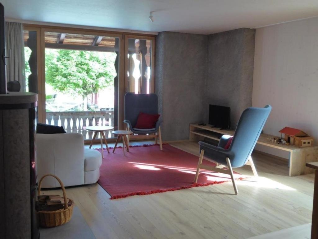 a living room with a couch and chairs and a table at Biala - BioBergün in Bergün