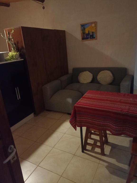 a living room with a couch and a table at Hospedaje Cardones in Maimará