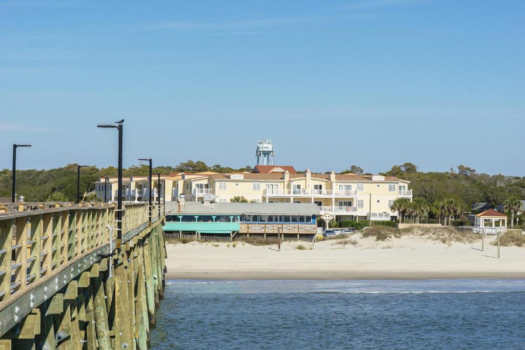 a bridge over the water next to a beach at Clearly Hooked in Oak Island