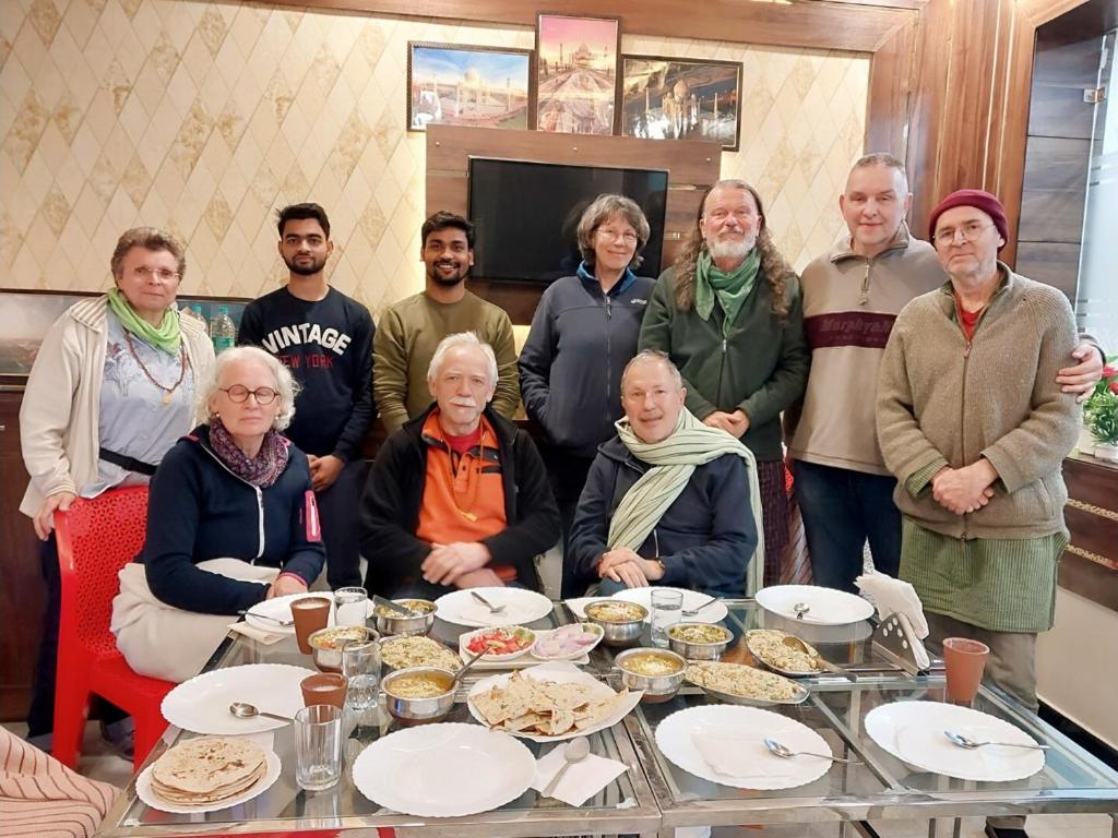 a group of people standing around a table with food at Taj Nice Point Manage by Taj Sunrise Group in Agra