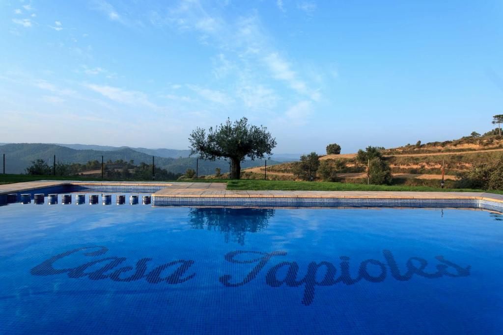a blue swimming pool with the words cape trogir at Casa Tapioles in Basella