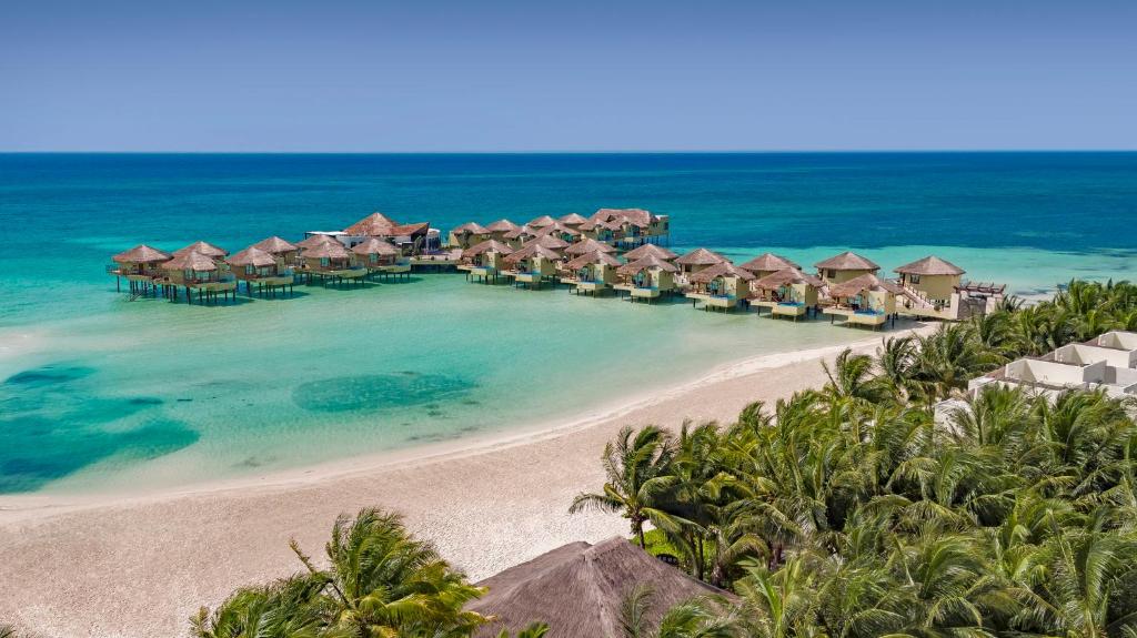 an aerial view of a resort on the beach at Palafitos Overwater Bungalows at El Dorado Maroma, Gourmet All Inclusive by Karisma - Adults Only in Playa del Carmen