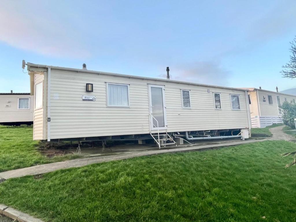 a mobile home is parked in a yard at Our Lodge at Newquay Bay NB35 in Newquay