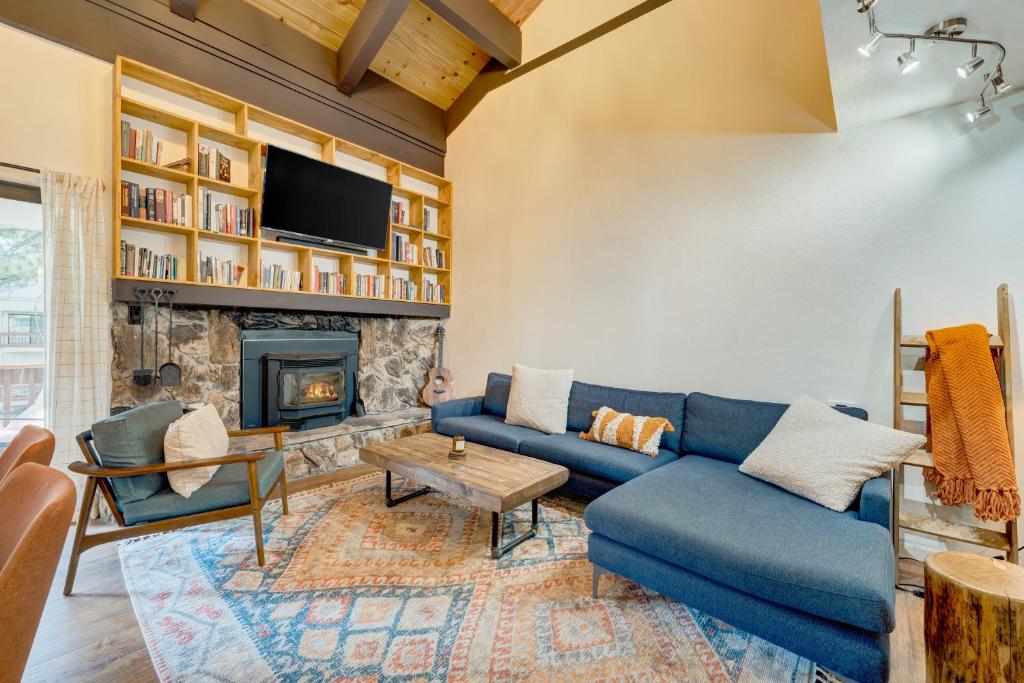 a living room with a blue couch and a fireplace at Alder Grove in Incline Village