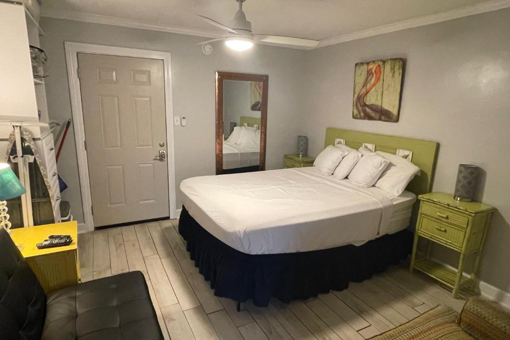 a bedroom with a bed with white sheets and pillows at Beachview 204 in Gulf Shores