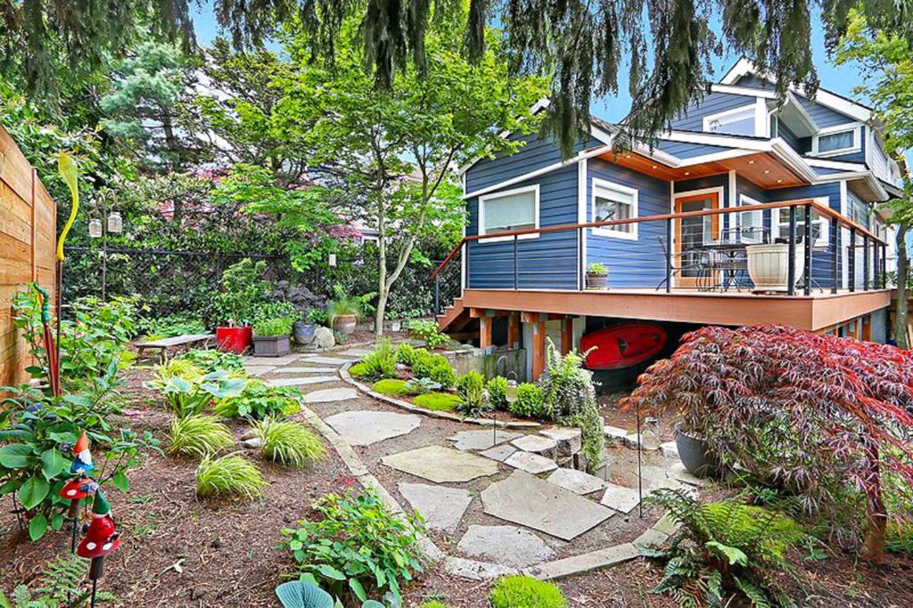 a blue house with a stone walkway in a garden at Lake Washington Adventures in Seattle