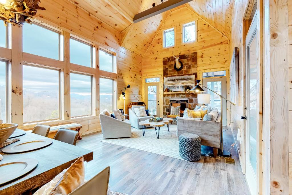 ein Wohnzimmer mit Holzwänden und Fenstern in der Unterkunft Mountain Memories in Sevierville