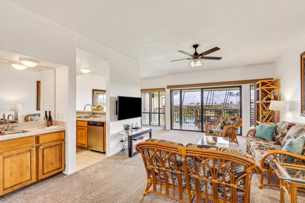 a living room with a couch and a table at Poipu Sands 221 in Koloa