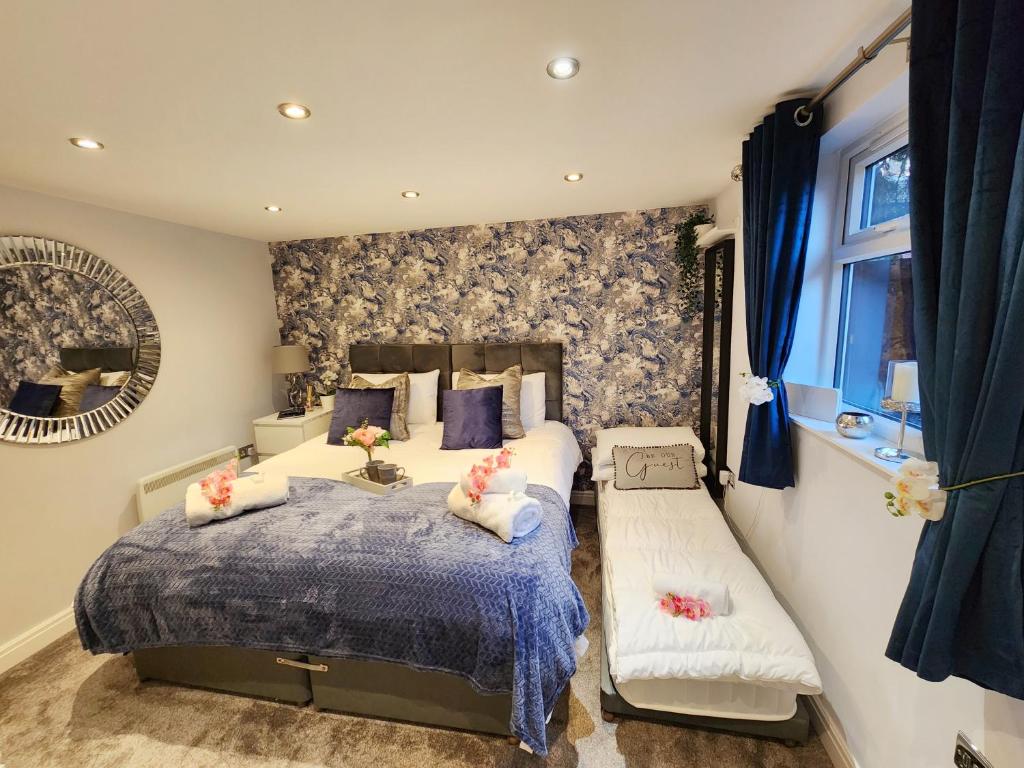 a bedroom with a bed and a bench in it at Studio Apartment The Den Colnbrook in Colnbrook