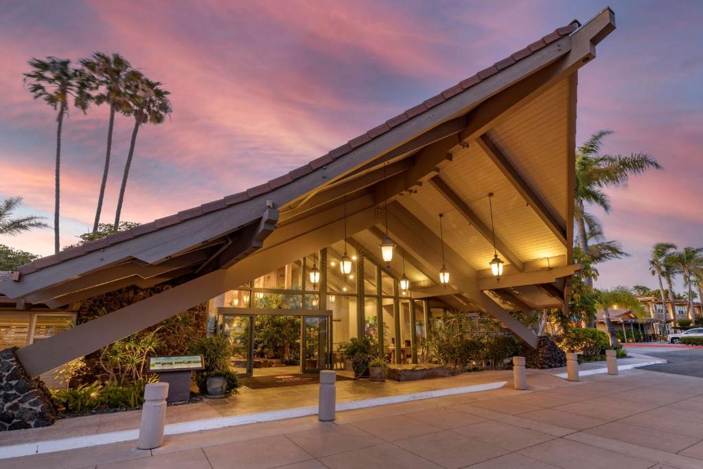 a building with an awning and palm trees at Best Western PLUS Island Palms Hotel & Marina in San Diego