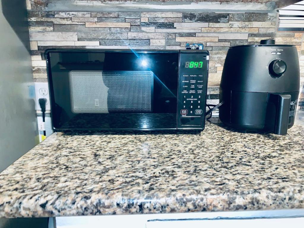 a microwave and a toaster oven sitting on a counter at The Doze Off in Houston