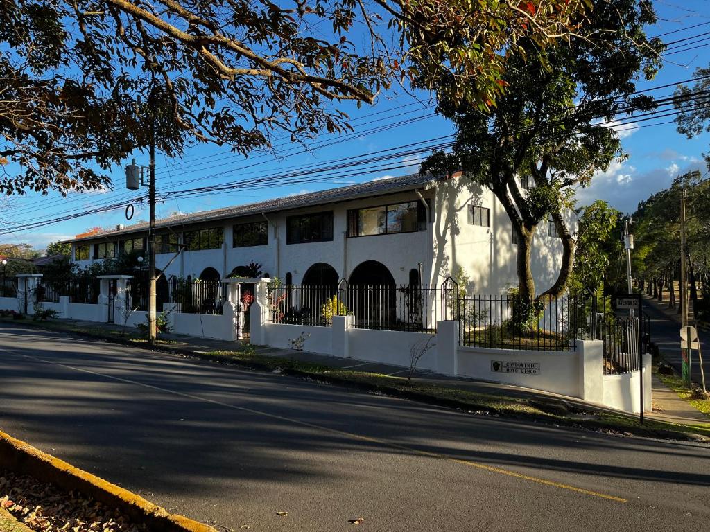 a white building on the side of a street at Green Volcano San Jose in San José