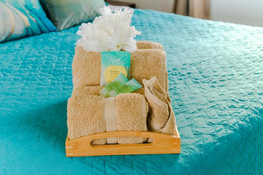 a towel holder sitting on top of a bed at The Hidden Cottage in Welches Hill