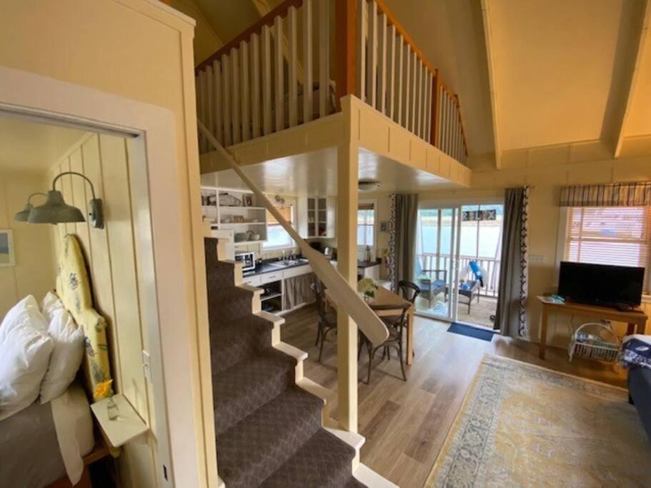 a staircase in a house with a living room at Floating Cottage on the River Nantucket in Savanna