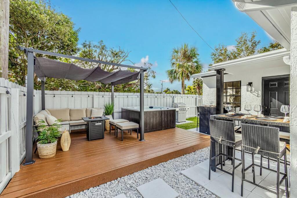 a backyard with a hot tub and a grill at * NEW* The Bungalow Jupiter! - Moremoments Rentals in Jupiter