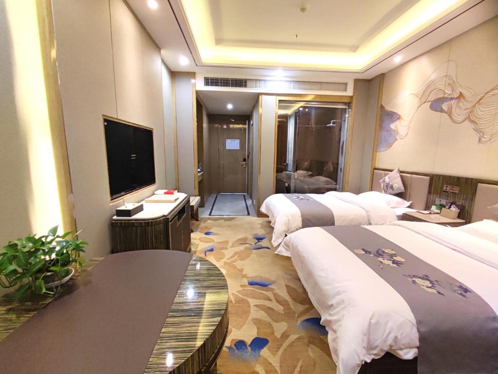 Postel nebo postele na pokoji v ubytování Zhangye KAI RUI Hotel