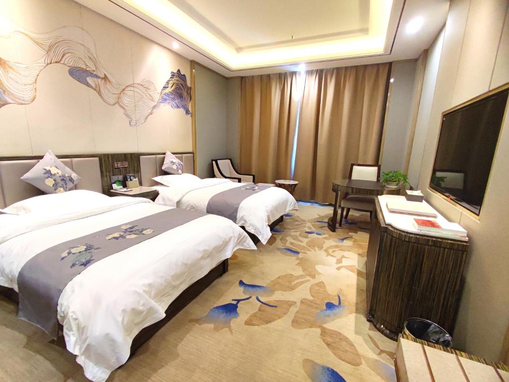 Postel nebo postele na pokoji v ubytování Zhangye KAI RUI Hotel