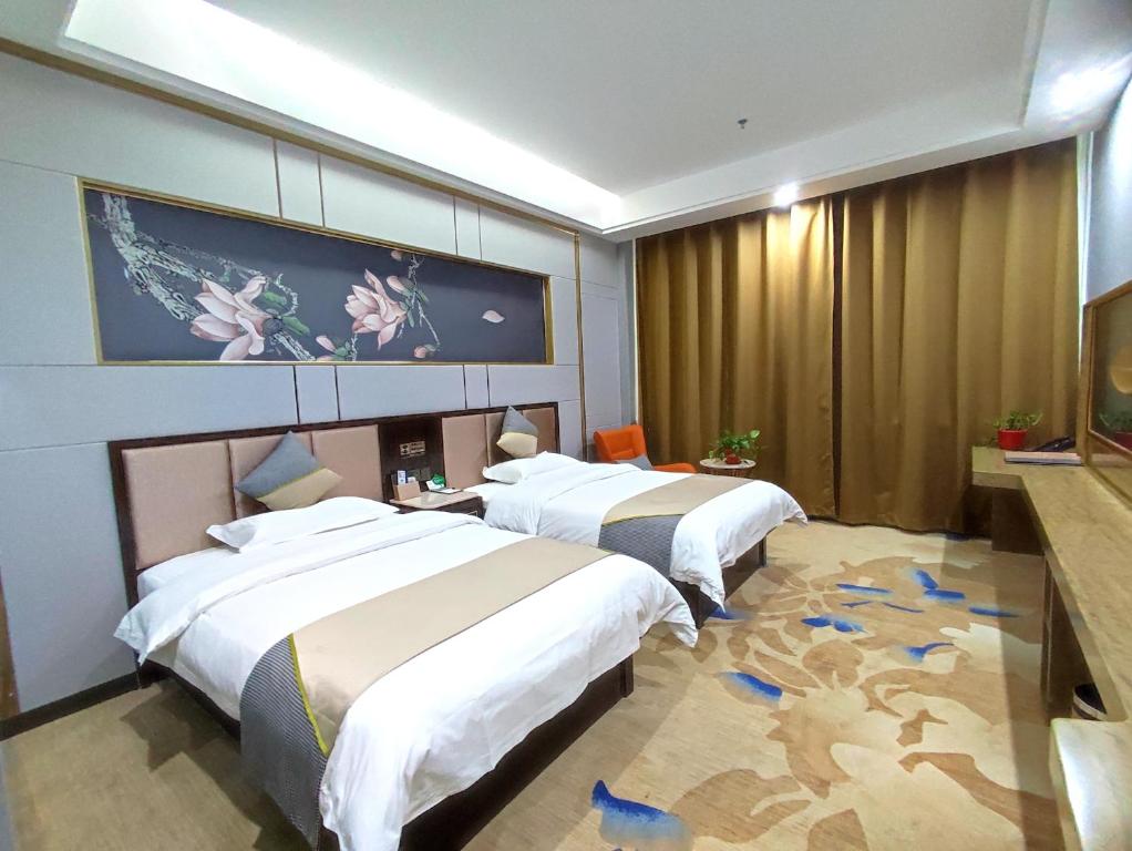 Postel nebo postele na pokoji v ubytování Zhangye KAI RUI Hotel