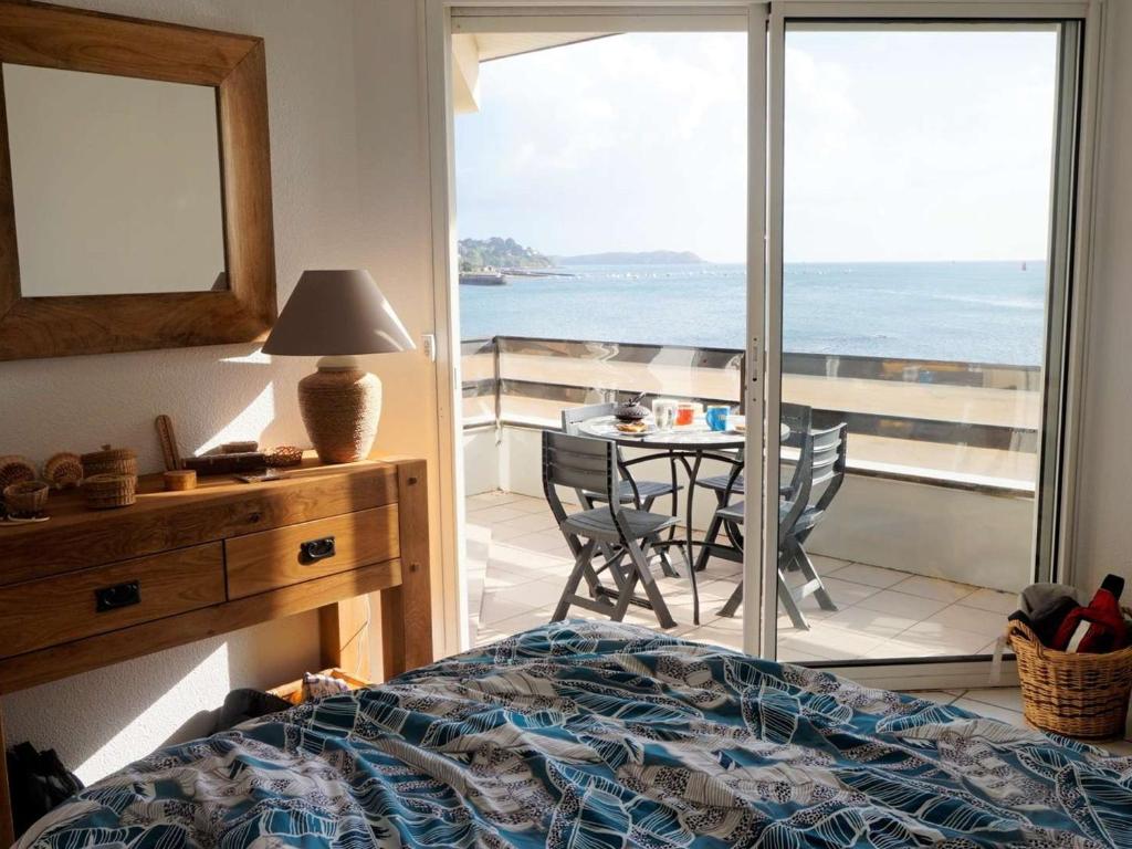 a bedroom with a bed and a view of the ocean at Appartement Perros-Guirec, 2 pièces, 4 personnes - FR-1-368-293 in Perros-Guirec