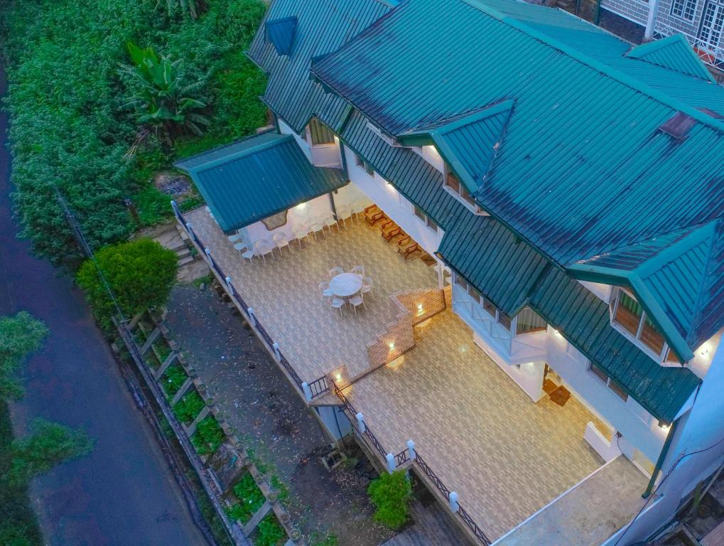 an overhead view of a house with a blue roof at Blue Moon Residency in Nuwara Eliya