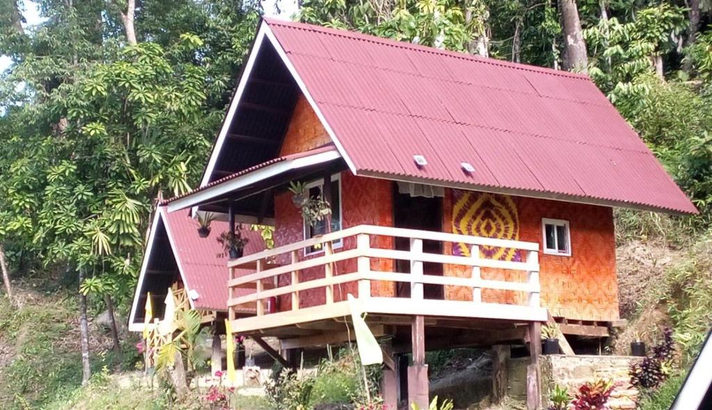 a small house with a red roof at Tentstar Eco Resort in San Vicente