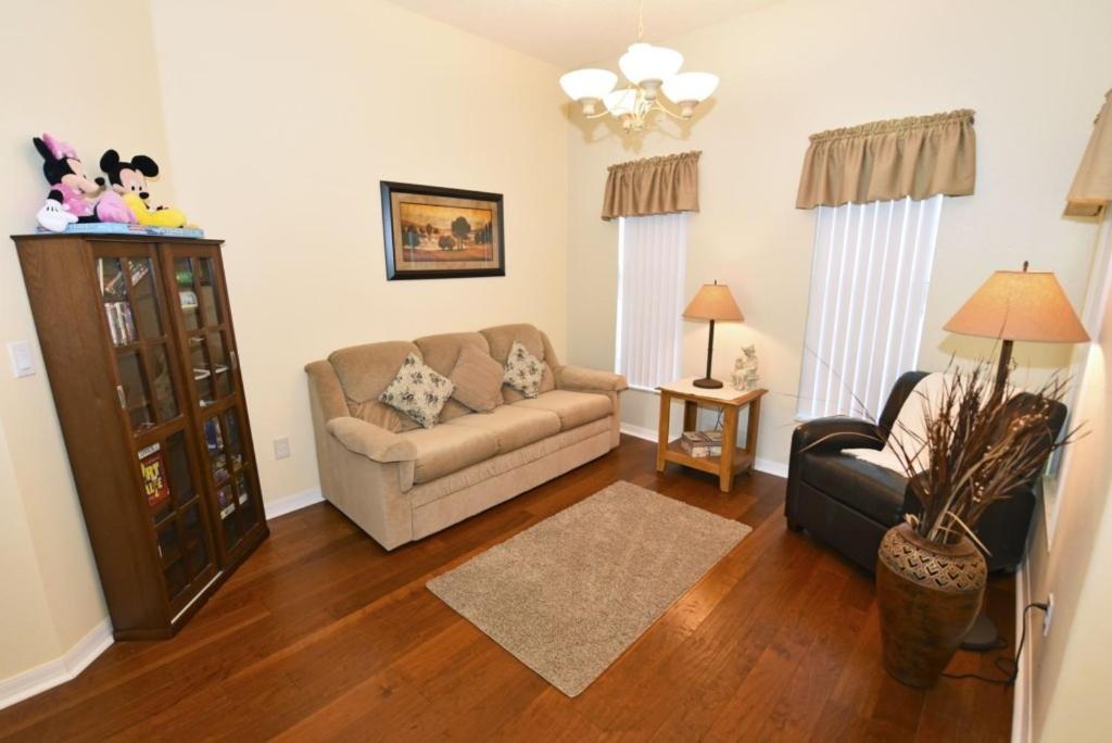a living room with a couch and a chair at Lovely Lakeside 4-Bed Pool Home at Villa Sol-3125 home in Kissimmee