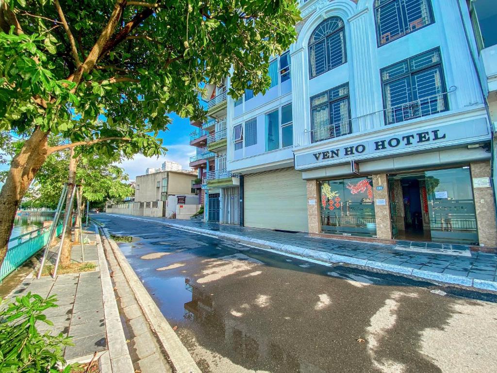 an empty street in front of a building at Ven Hồ Hotel in Hanoi
