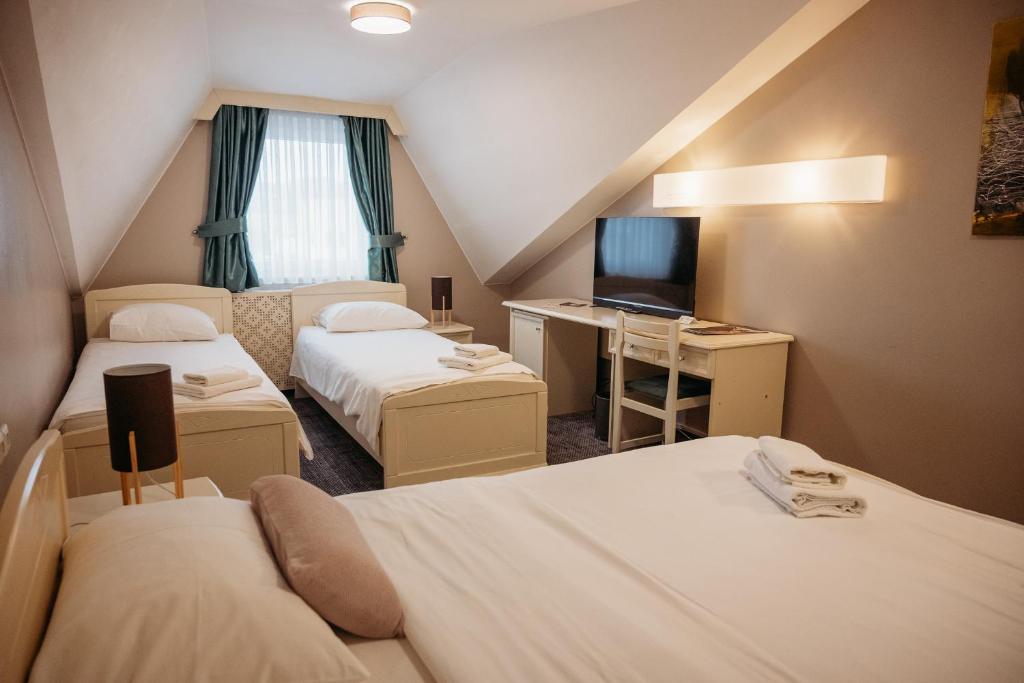 Postel nebo postele na pokoji v ubytování Hotel Kunst