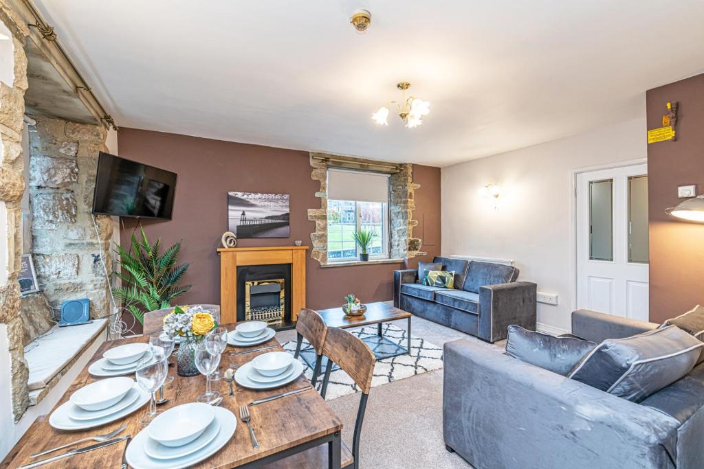 a living room with a couch and a table at Scalebar Bridge End Mill in Settle