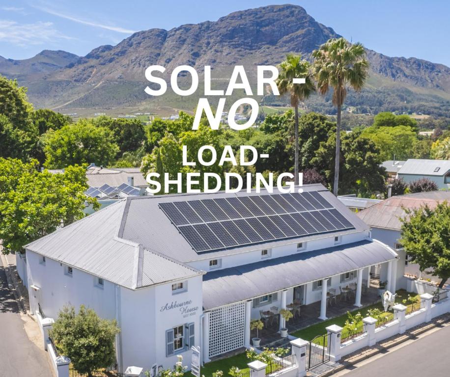 una casa con paneles solares encima en Ashbourne Boutique Guest House, en Franschhoek