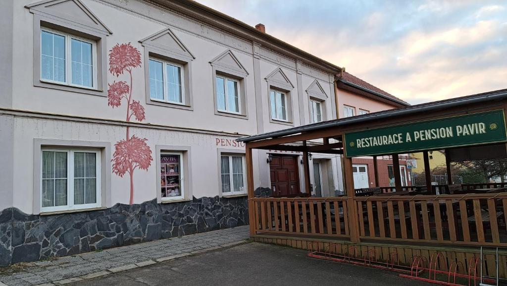 a building with a sign on the side of it at Pension PAVIR in Židlochovice