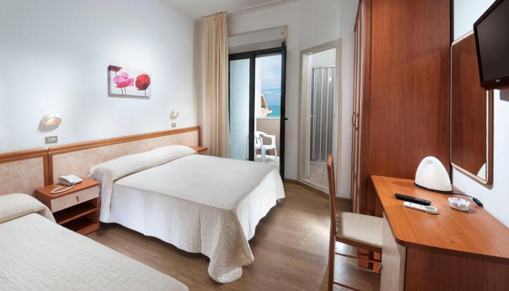 Postel nebo postele na pokoji v ubytování Hotel Olympic