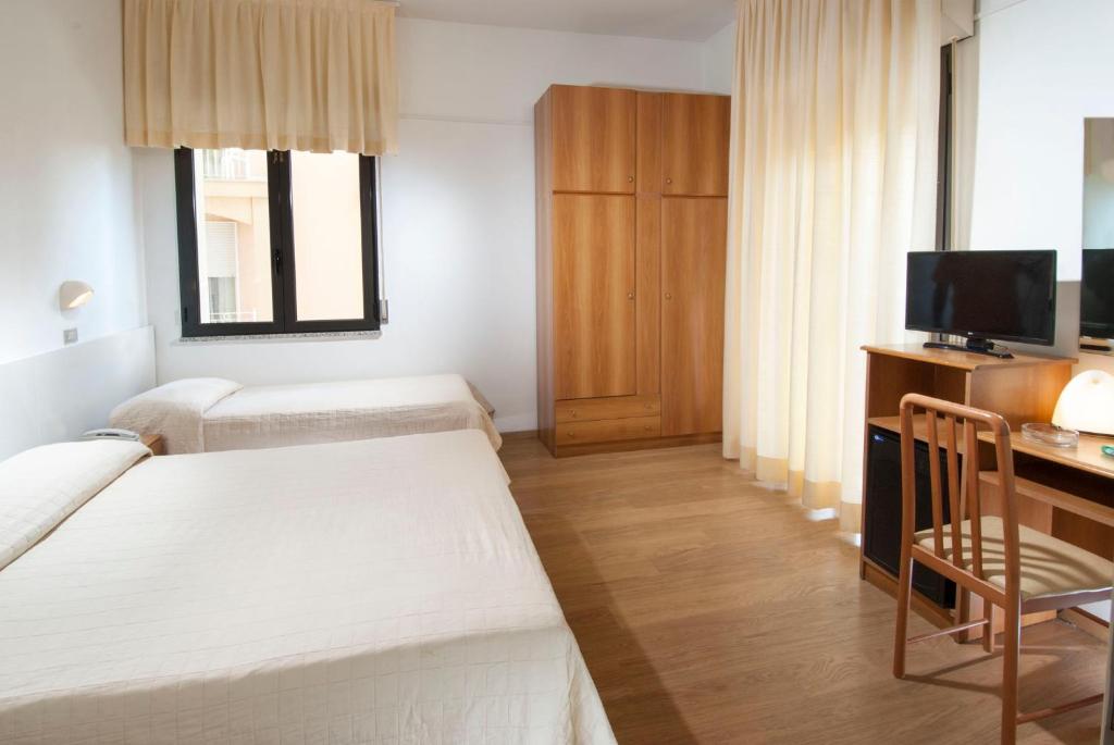 Postel nebo postele na pokoji v ubytování Hotel Olympic
