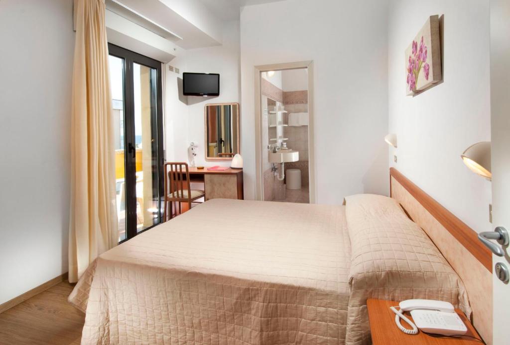 Postel nebo postele na pokoji v ubytování Hotel Olympic