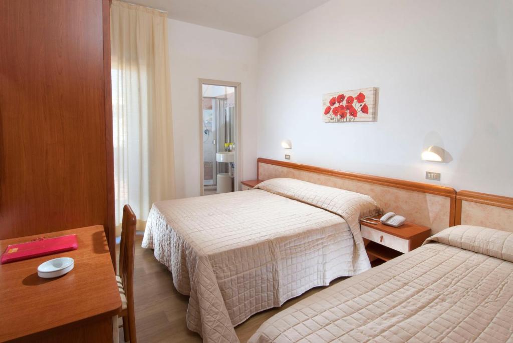 Postel nebo postele na pokoji v ubytování Hotel Olympic