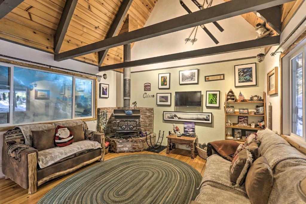 a living room with a couch and a fireplace at Quintessential Tahoe Cabin with Private Hot Tub in South Lake Tahoe