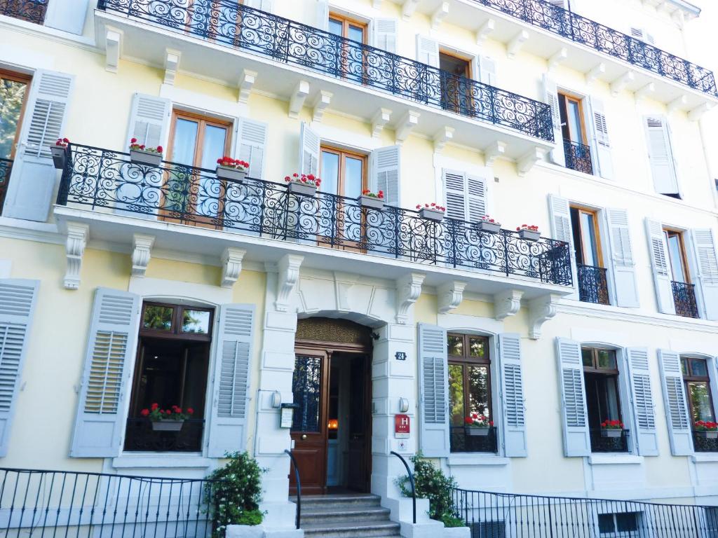 een wit gebouw met een balkon bij Hôtel Gallia in Aix-les-Bains