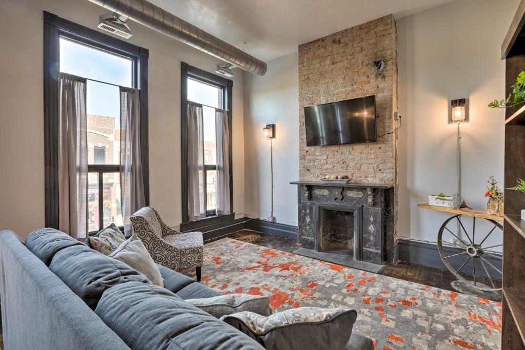 a living room with a couch and a fireplace at Downtown Cherokee Iowa Vacation Rental in Cherokee