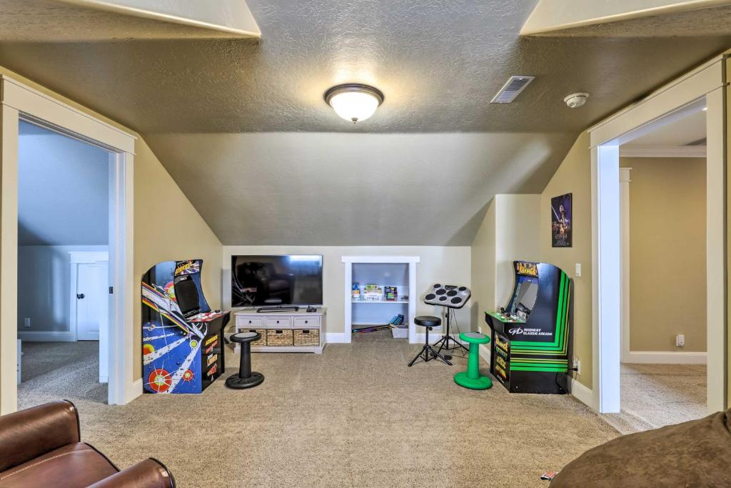 uma sala de estar com jogos de arcada e uma televisão de ecrã plano em Utah Abode - Deck, Arcade Games and Near Skiing em Midway